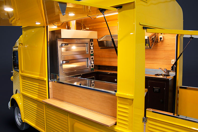 mobile pizzeria built on a vintage yellow citroen with two electric ovens