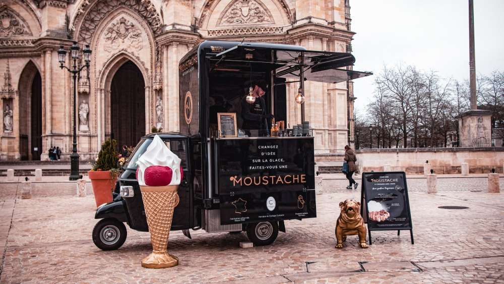 Mustache mobile ice cream truck built on a black Piaggio V-Curve Ape